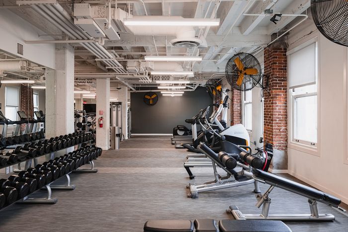 Spacious, modern fitness center with state-of-the-art equipment and large windows for natural light.