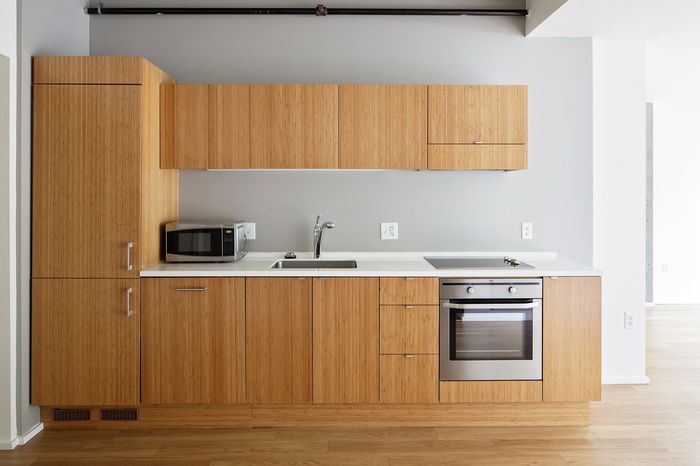 Contemporary kitchen with sleek bamboo cabinetry, modern appliances, and a minimalist design.