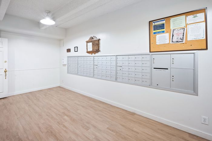 Bright and welcoming mailroom with modern mailboxes and a community notice board, enhancing convenience and connectivity for residents.