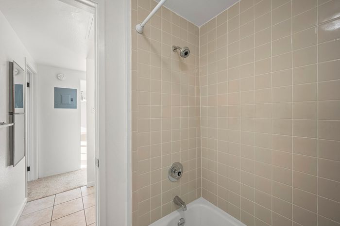 Inviting bathroom with elegant beige tilework and a chic shower area, offering modern comfort and style.