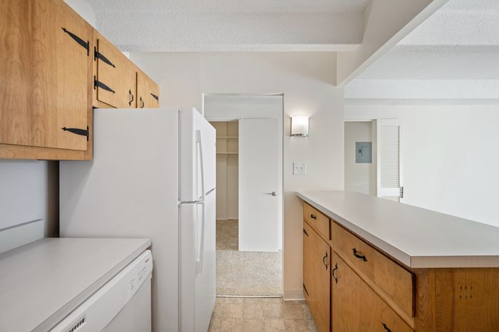 Bright and inviting kitchen with classic wooden cabinetry, modern appliances, and a spacious prep area, offering a perfect blend of functionality and style.
