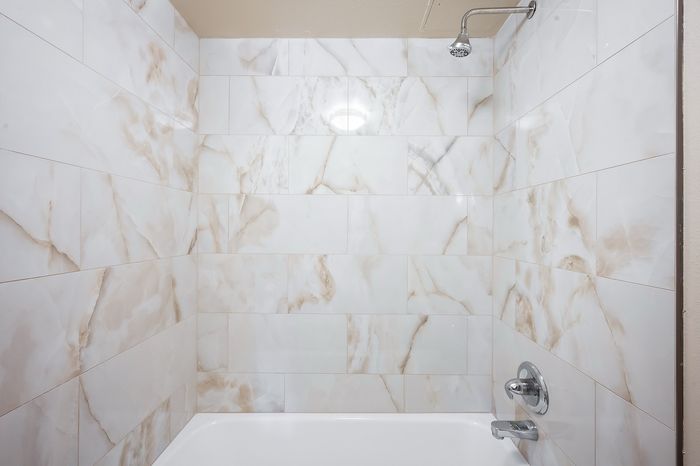 Luxurious bathroom with elegant marble tiles and modern fixtures in a serene, spa-like atmosphere.