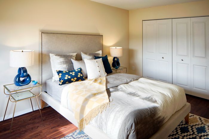 Cozy bedroom with elegant bedding, stylish side tables, and soft lighting for a serene atmosphere.