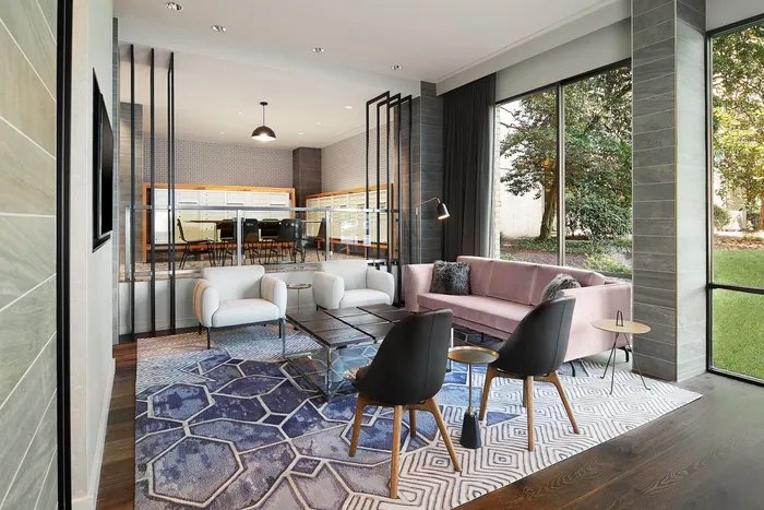 Chic and modern living space with large windows, plush pink sofa, and stylish geometric rug, offering a blend of comfort and elegance.