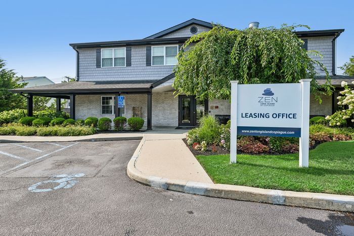 Inviting leasing office at Zen Long Island with well-maintained landscaping and accessible parking.