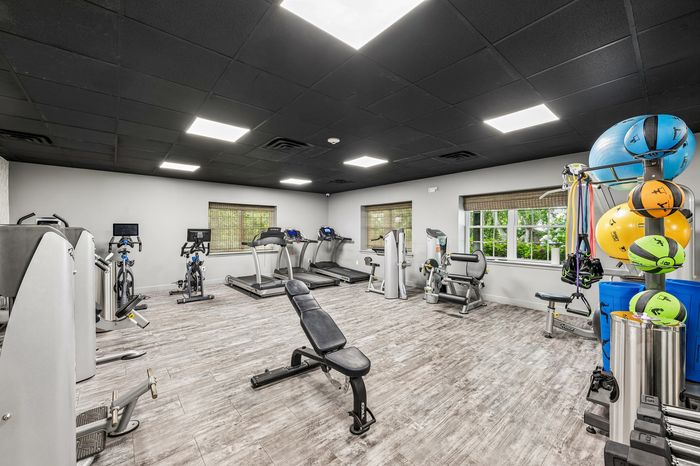 Modern fitness center with state-of-the-art gym equipment, bright interior, and ample workout space.
