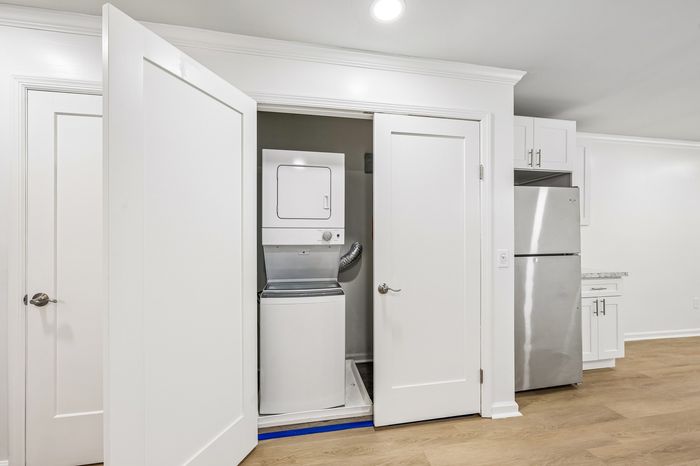 Modern apartment with sleek in-unit laundry and stainless steel kitchen appliances, offering convenience and style.
