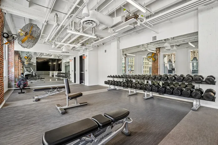 Modern fitness center with state-of-the-art equipment, sleek design, and bright space, perfect for a refreshing workout.
