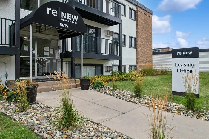 Inviting entrance to ReNew Meadow Lake Leasing Office, surrounded by vibrant landscaping and modern architecture.