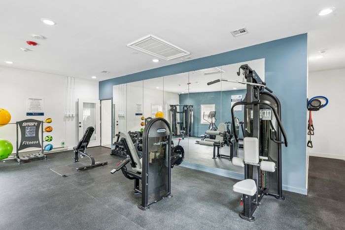 Modern fitness center showcasing state-of-the-art gym equipment, mirrored walls, and ample workout space.
