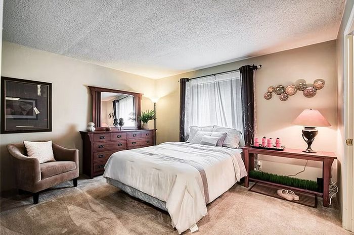 Inviting bedroom with elegant decor, soft lighting, and a cozy queen-sized bed, perfect for relaxation.