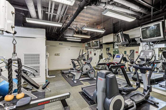 Modern fitness center equipped with state-of-the-art cardio machines and strength training equipment, perfect for an invigorating workout.