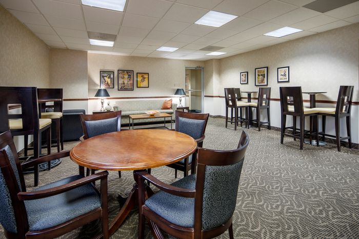 Elegant communal lounge with stylish wooden furniture, inviting seating areas, and modern decor.