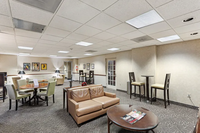 Elegant and spacious lounge area featuring modern furnishings, cozy seating, and tasteful artwork, ideal for relaxation and social gatherings.