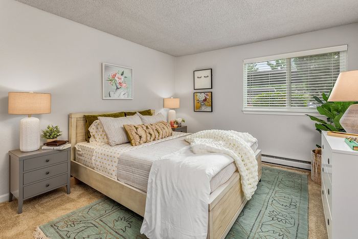 Tranquil bedroom oasis featuring plush bedding, cozy lighting, and modern decor with natural light streaming through large windows.