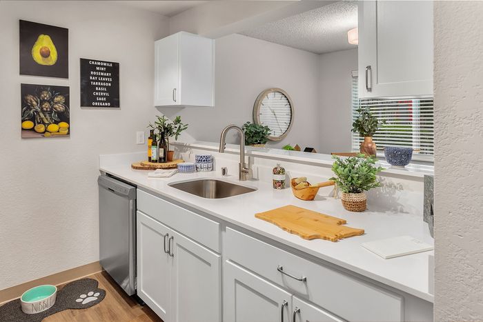 Bright and inviting kitchen with sleek white cabinetry, modern fixtures, and elegant decor creating a refreshing atmosphere.