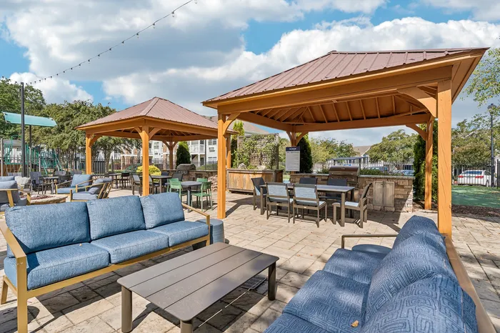 Charming outdoor patio with stylish seating and wooden pergolas, perfect for entertaining and relaxation.