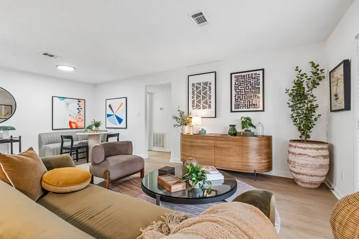 Chic living room with modern decor, plush seating, and stylish artwork, creating a warm and inviting atmosphere.