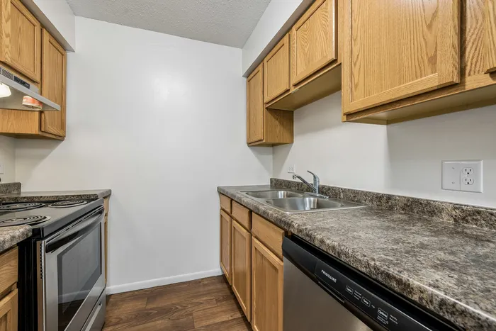 Contemporary kitchen with sleek brown cabinets, modern appliances, and spacious countertops.