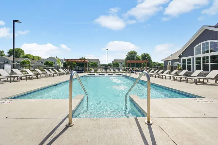 Heated outdoor pool at The 85 at Maple Grove featuring lounge seating and community space in Madison, Wisconsin.