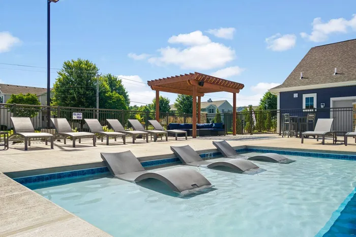 Heated outdoor pool at The 85 at Maple Grove featuring lounge seating and community space in Madison, Wisconsin.