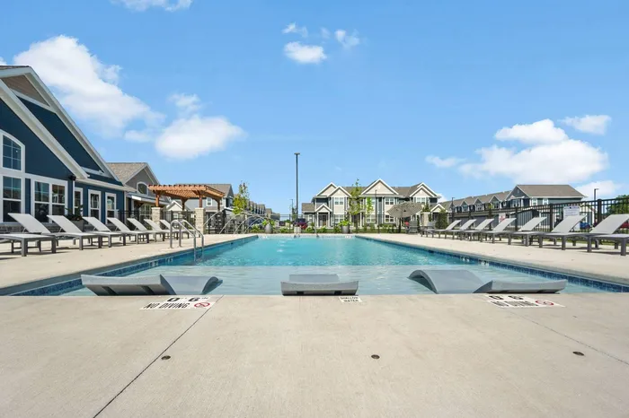 Heated outdoor pool at The 85 at Maple Grove featuring lounge seating and community space in Madison, Wisconsin.