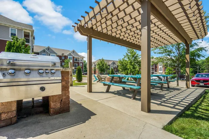 Outdoor picnic area at Elan Apartments in Fitchburg, Wisconsin offering shared seating and green space for residents.