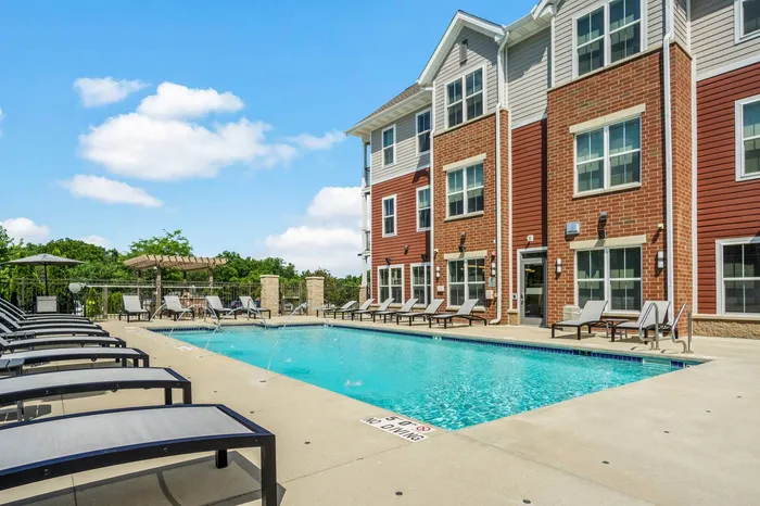Sparkling outdoor swimming pool at Elan Apartments in Fitchburg, Wisconsin designed for relaxation and recreation.