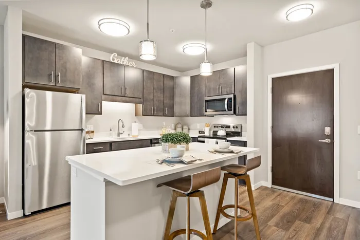Apartment kitchen at The 85 at Maple Grove featuring updated finishes and functional layout in Madison, Wisconsin.