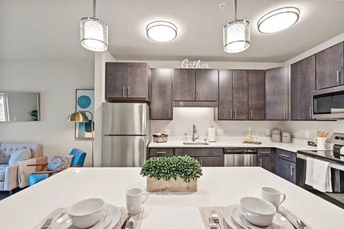 Apartment kitchen at The 85 at Maple Grove featuring updated finishes and functional layout in Madison, Wisconsin.