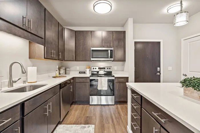 Apartment kitchen at The 85 at Maple Grove featuring updated finishes and functional layout in Madison, Wisconsin.