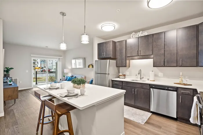Apartment kitchen at The 85 at Maple Grove featuring updated finishes and functional layout in Madison, Wisconsin.
