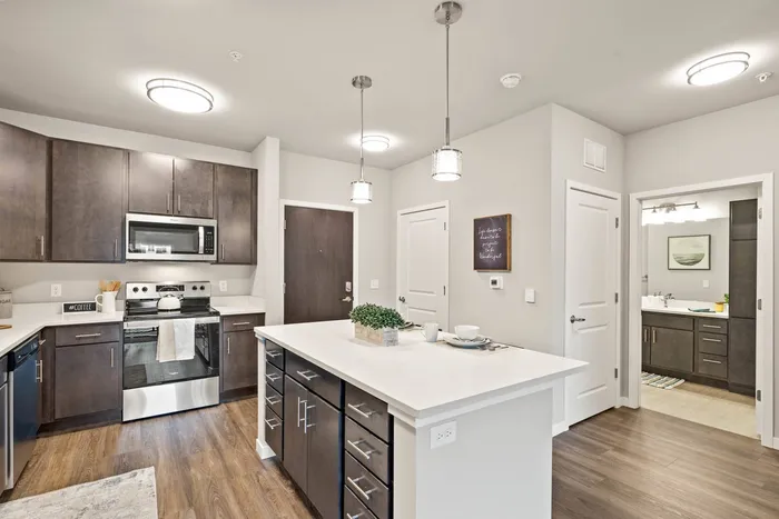 Apartment kitchen at The 85 at Maple Grove featuring updated finishes and functional layout in Madison, Wisconsin.