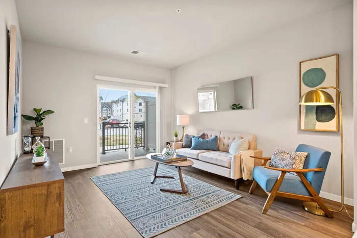 Apartment living room at The 85 at Maple Grove with open layout and natural light in Madison, Wisconsin.