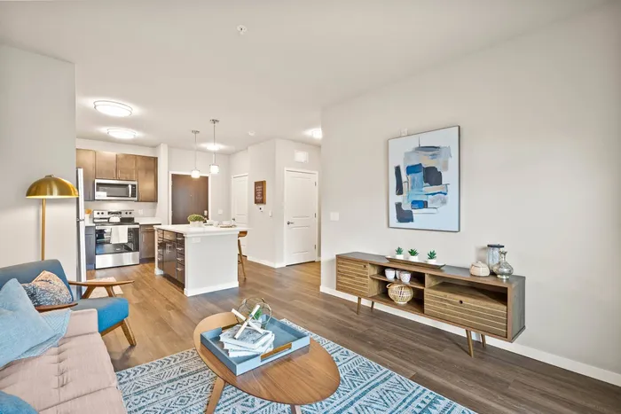 Apartment living room at The 85 at Maple Grove with open layout and natural light in Madison, Wisconsin.