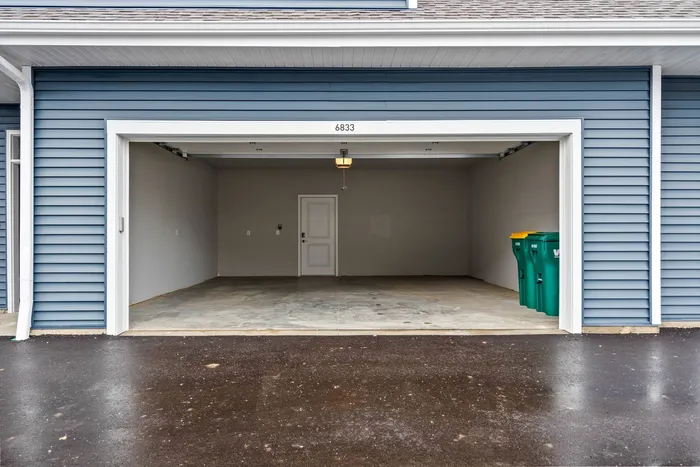 Attached garage at The 85 at Maple Grove providing direct access and storage for townhomes.