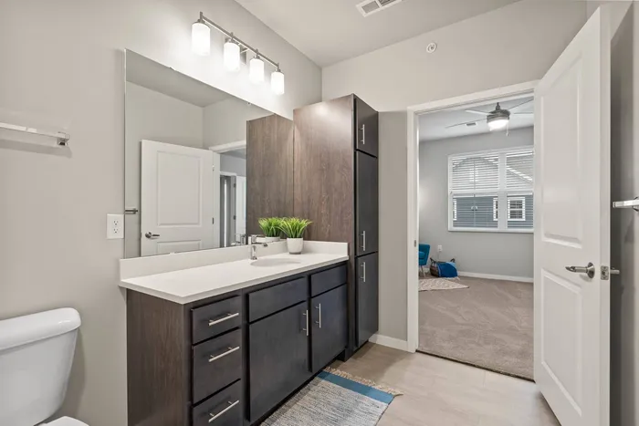 Stacked flats bedroom at The 85 at Maple Grove offering comfortable private living space in Madison, Wisconsin.