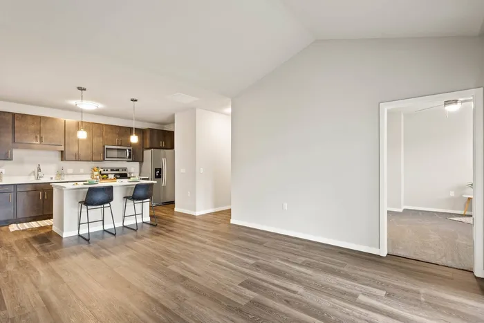 Stacked flats living room at The 85 at Maple Grove with open layout and natural light in Madison, Wisconsin.
