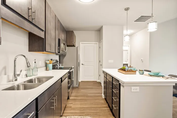 Stacked flats kitchen at The 85 at Maple Grove featuring modern finishes and efficient layout in Madison, Wisconsin.