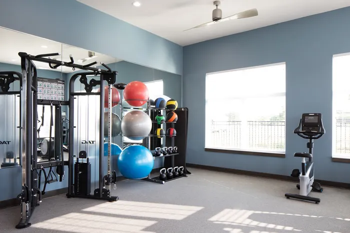 Fitness center at Seasons at North Aurora Apartments in North Aurora, Illinois equipped for cardio and strength training.