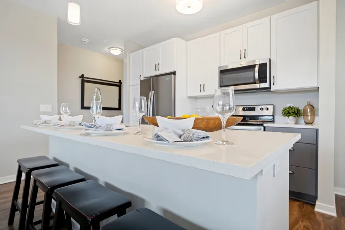 Apartment kitchen at Seasons at North Aurora Apartments in North Aurora, Illinois featuring updated cabinetry, countertops, and appliances.