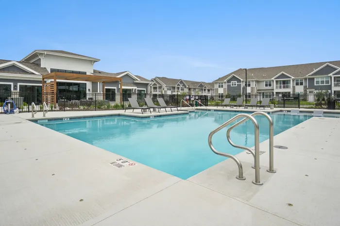 Resort-style swimming pool at Seasons at North Aurora Apartments in North Aurora, Illinois for resident use and outdoor relaxation.
