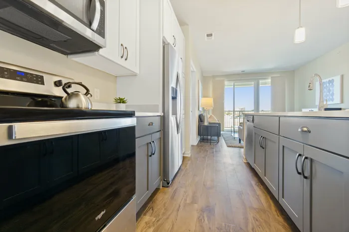 Apartment kitchen at Seasons at North Aurora Apartments in North Aurora, Illinois featuring updated cabinetry, countertops, and appliances.