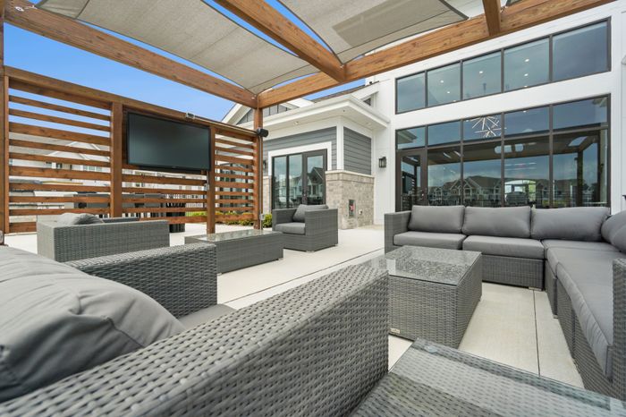 Outdoor pergola lounge at Seasons at Franklin Apartments in Franklin, Wisconsin providing shaded seating and outdoor gathering space.