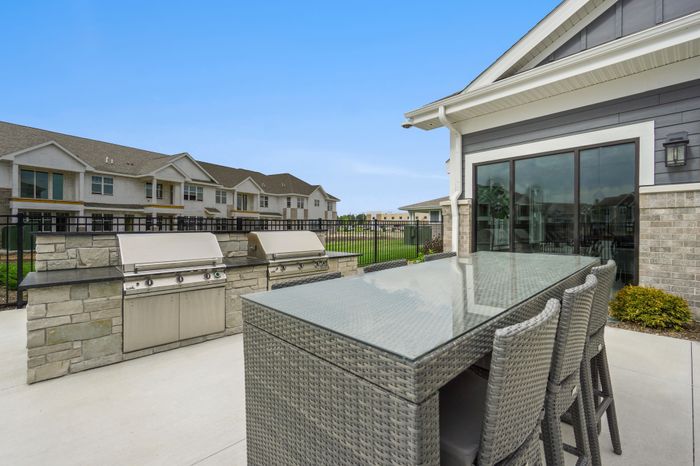 Outdoor grilling station at Seasons at Franklin Apartments in Franklin, Wisconsin offering space for outdoor cooking and dining.
