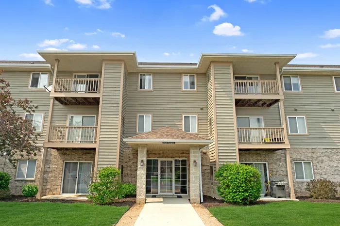 Exterior view of resident apartment buildings at Saddlebrook Apartments in Pewaukee, Wisconsin.