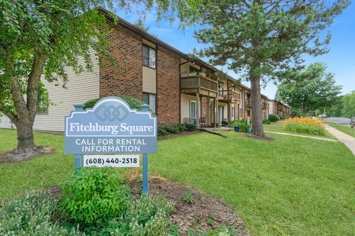 Fitchburg Square Apartments building exterior in Fitchburg, Wisconsin, featuring spacious 1 bedroom and 2 bedroom apartment homes in a residential setting.