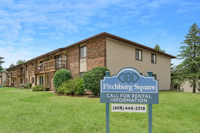 Fitchburg Square Apartments building exterior in Fitchburg, Wisconsin, featuring spacious 1 bedroom and 2 bedroom apartment homes in a residential setting.
