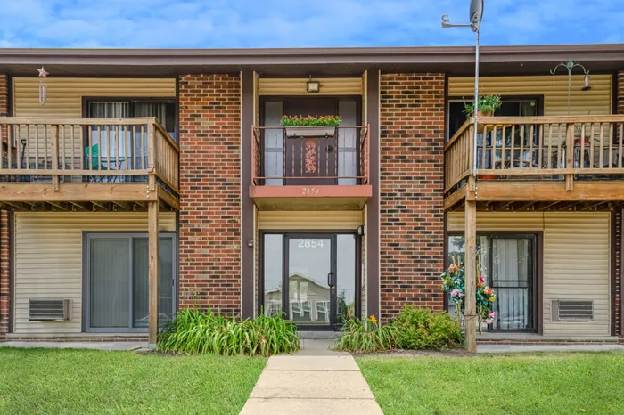 Fitchburg Square Apartments building exterior in Fitchburg, Wisconsin, featuring spacious 1 bedroom and 2 bedroom apartment homes in a residential setting.