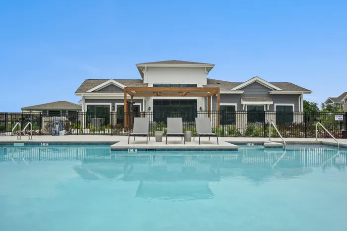 Resort-style pool at Seasons at Franklin Apartments in Franklin, Wisconsin featuring seating areas and space to relax outdoors.